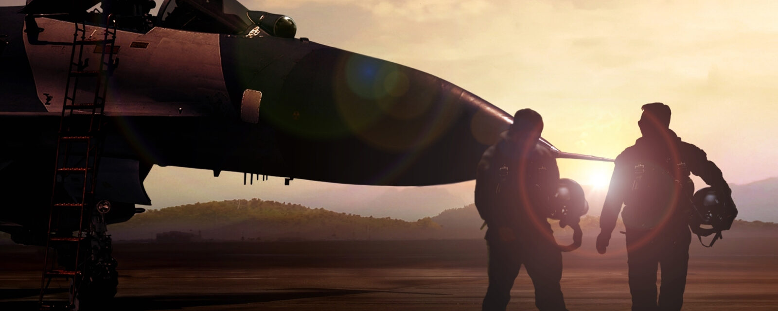 This is an image of two air force members walking away from the camera and towards a plane in the background.