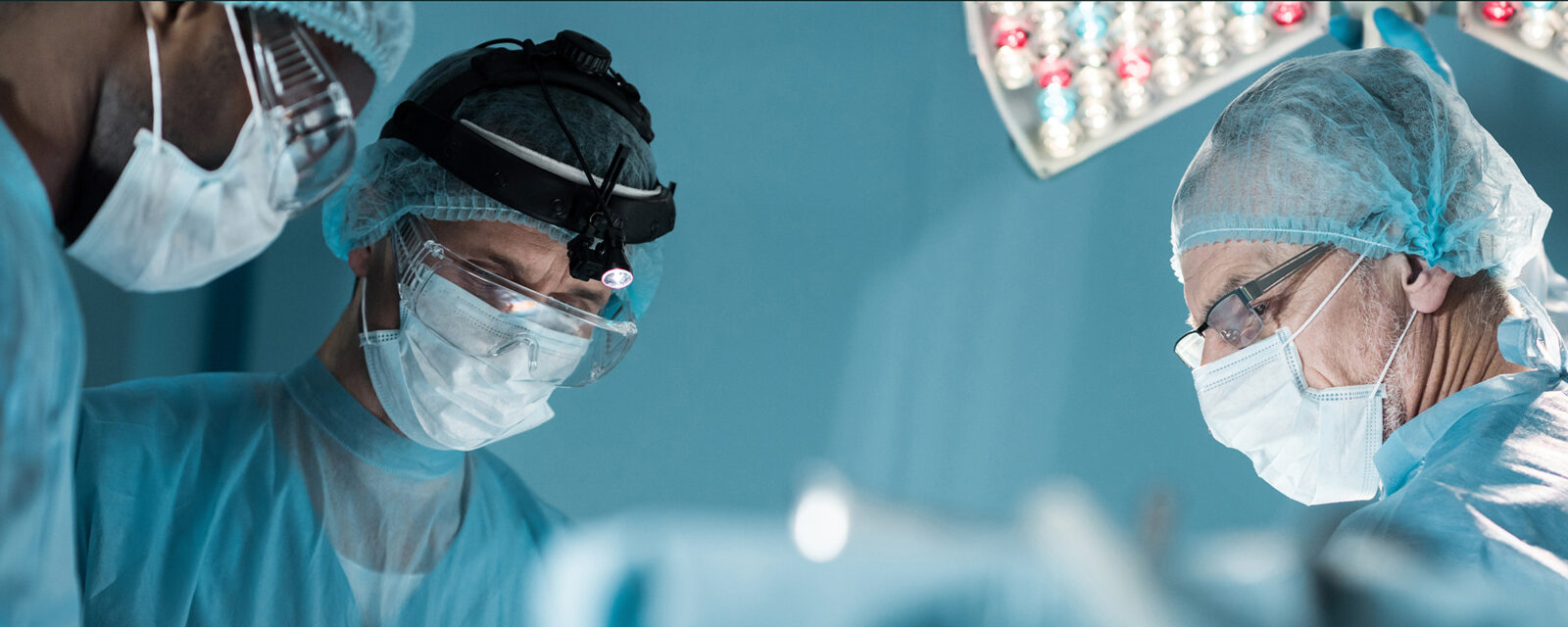 Close-up image of surgeons' faces while performing a pneumonectomy.