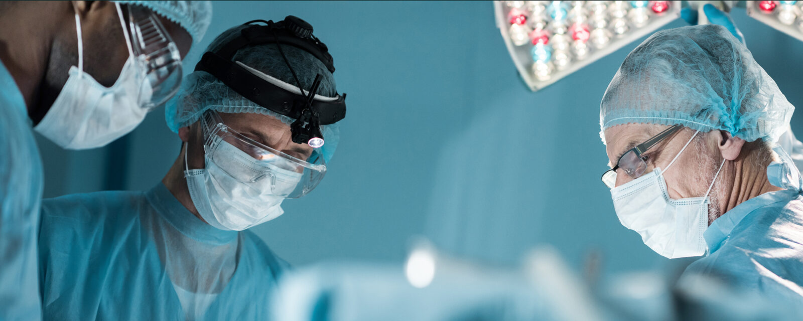 Close-up image of surgeons' faces while performing a cytoreductive surgery.