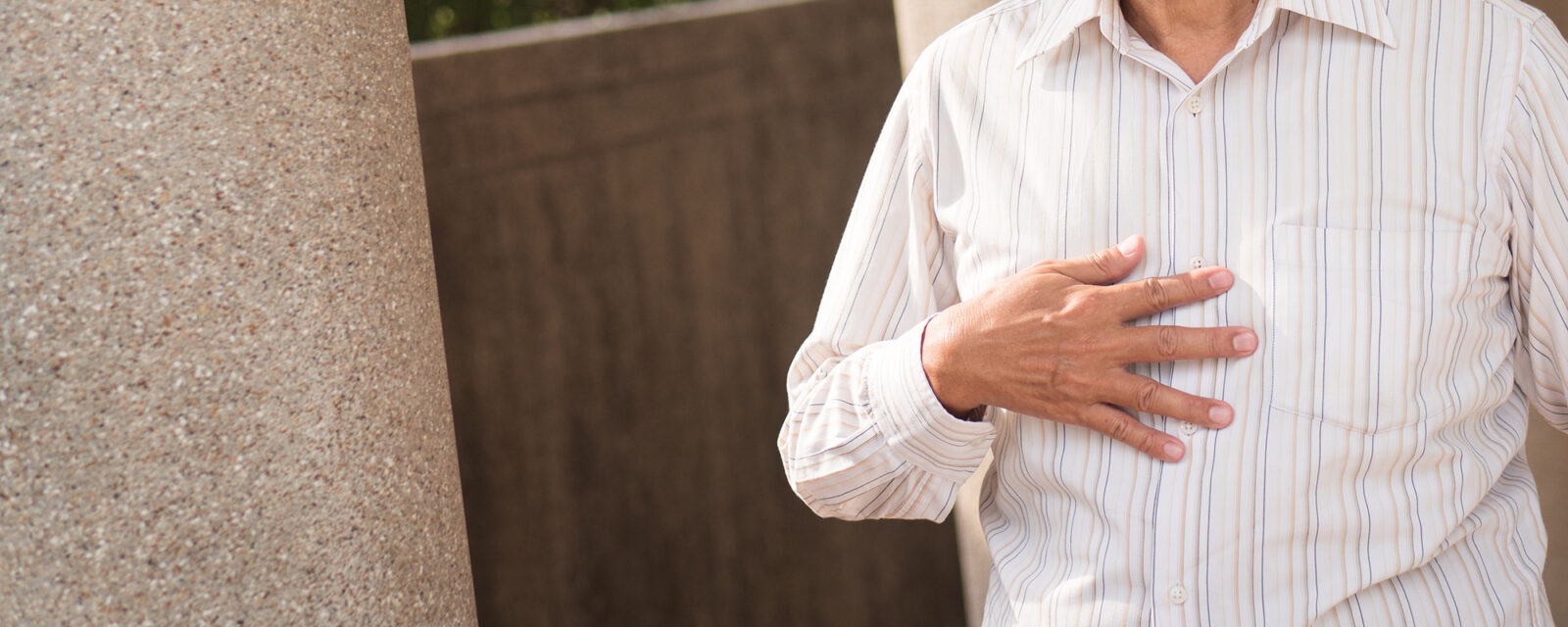 This is an image of a person holding their chest.