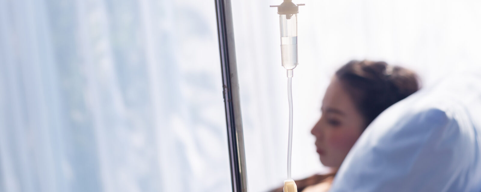 Out of focus image of a patient receiving chemotherapy treatment.