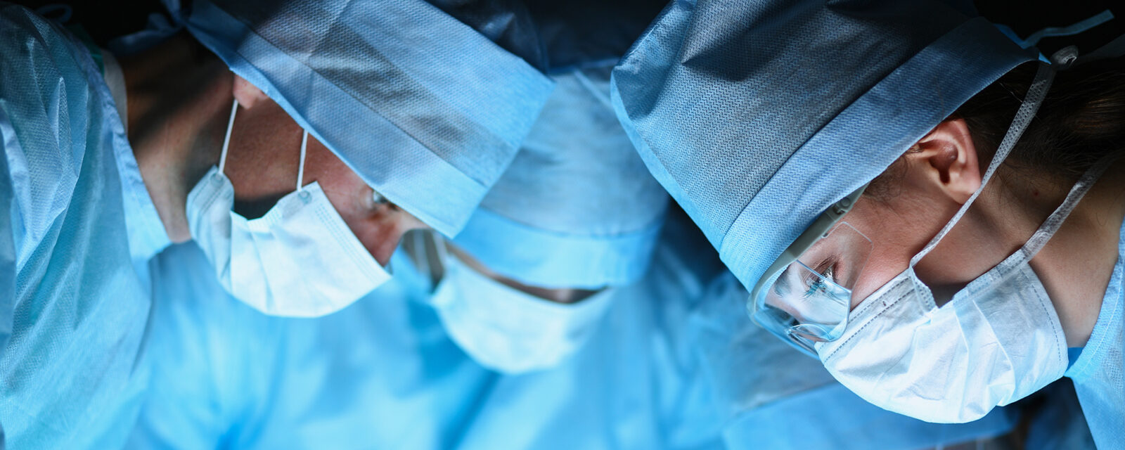Close-up image of surgeons' faces while performing pleurodesis surgery
