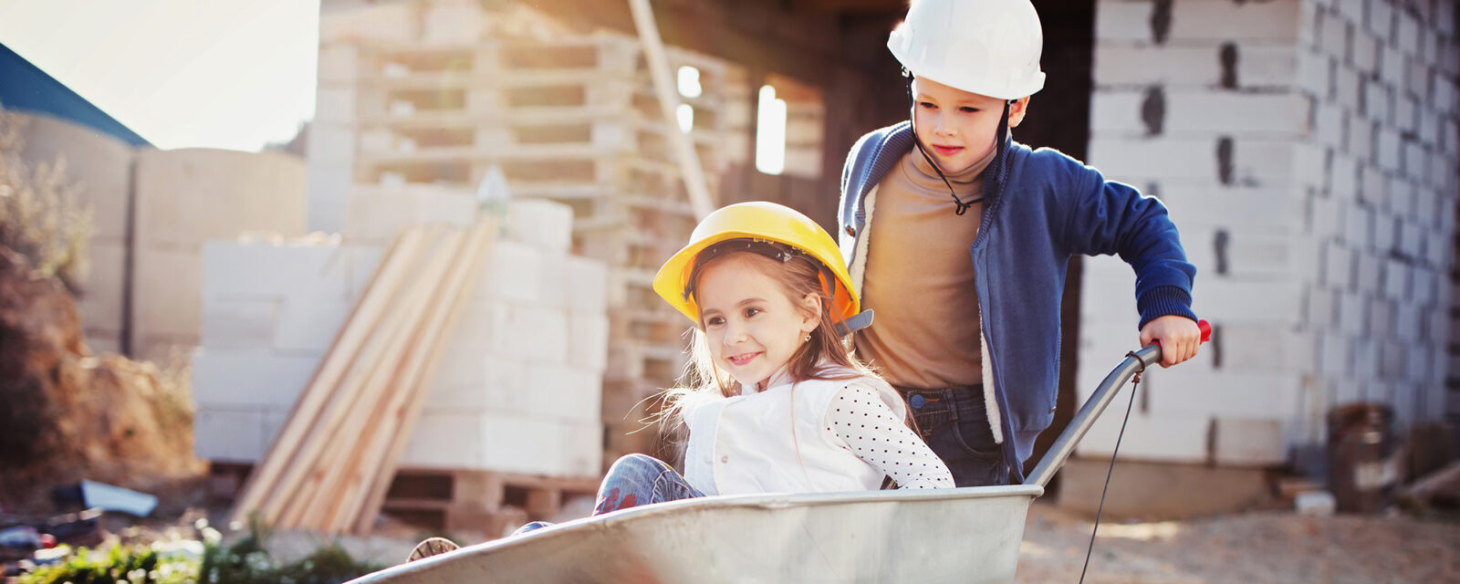 Image of two children playing in a construction site, potentially being exposed to asbestos.