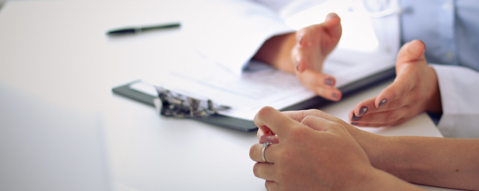 Close up image of hand gestures used as a doctor is explaining medical information to her patient.