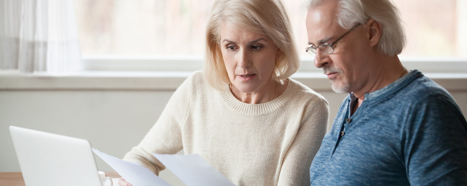 Image of a couple looking at informational papers together.