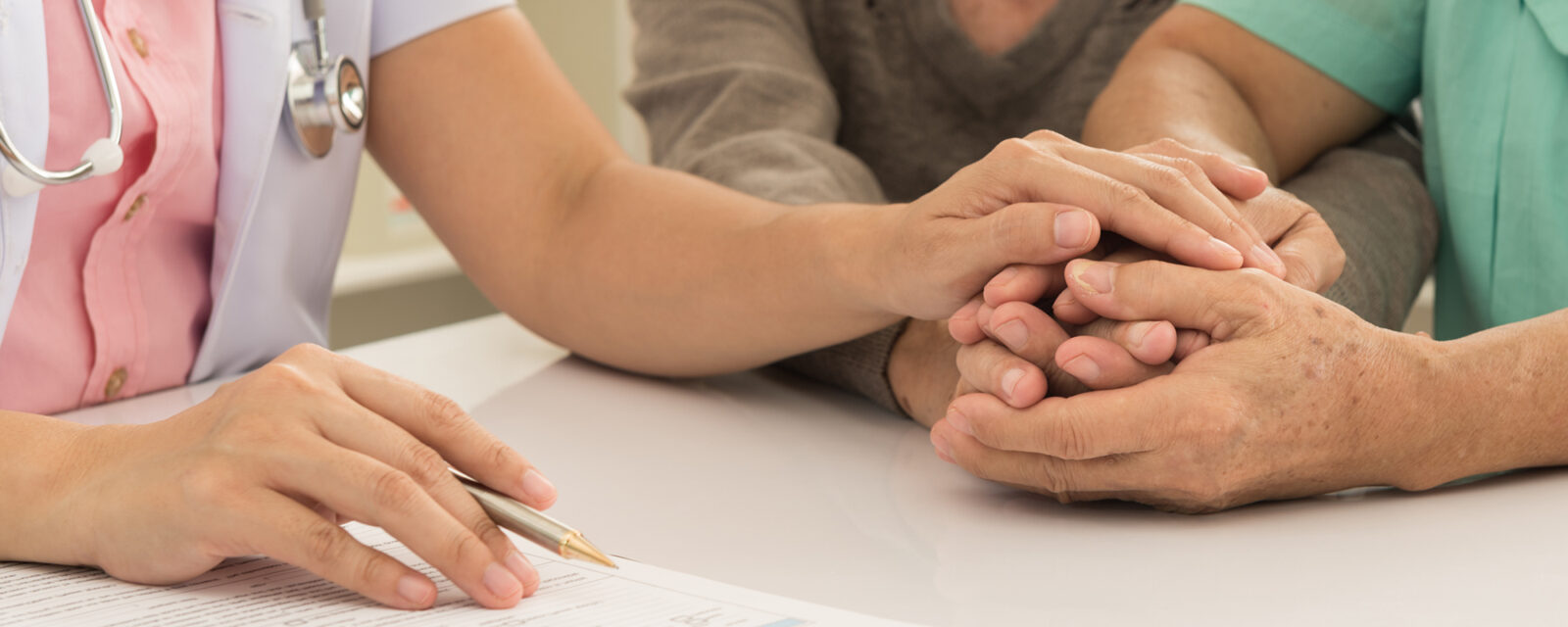 This is an image of a person being comforted after hearing the specifics about their life expectancy.