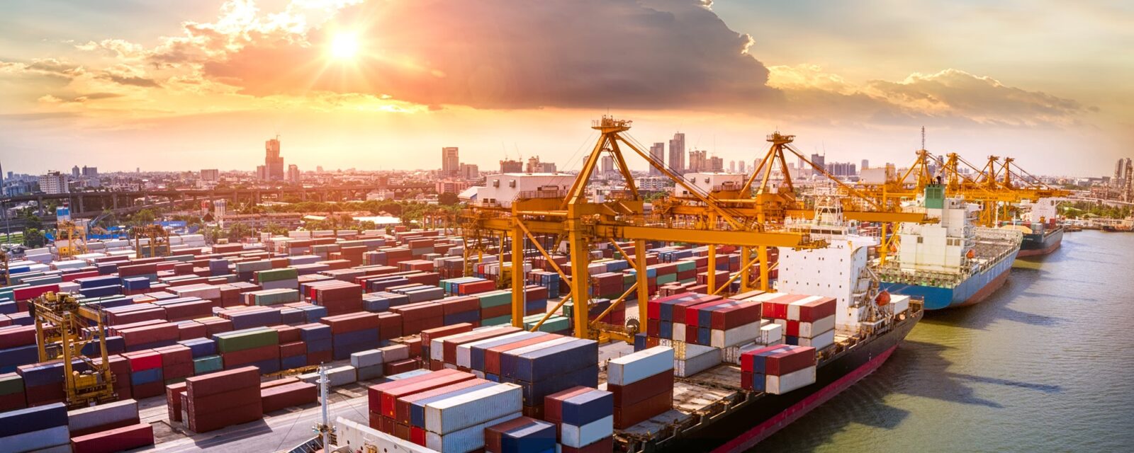 Logistics and transportation of Container Cargo ship and Cargo plane with working crane bridge in shipyards at sunrise, logistic import export and transport industry background