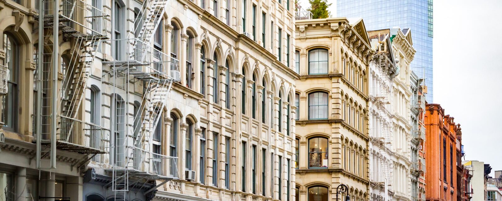 New modern building rises above the old historic buildings of SoHo in Manhattan, New York City
