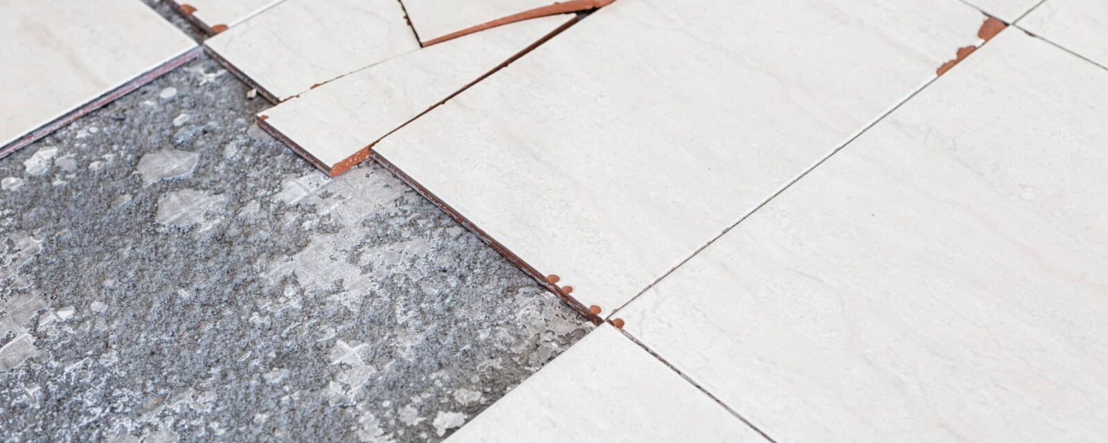Image of broken tiles on the floor.