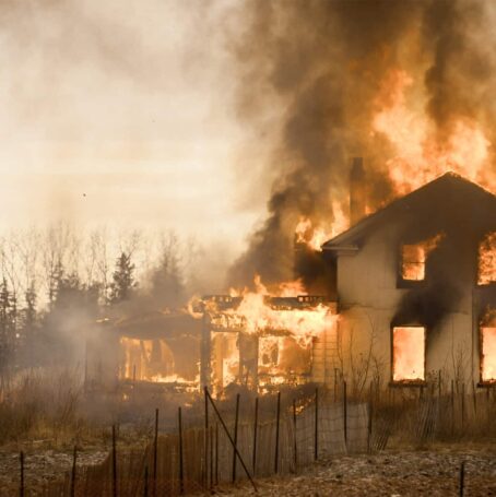 Burning farm house in an empty field in Ontario Canada.