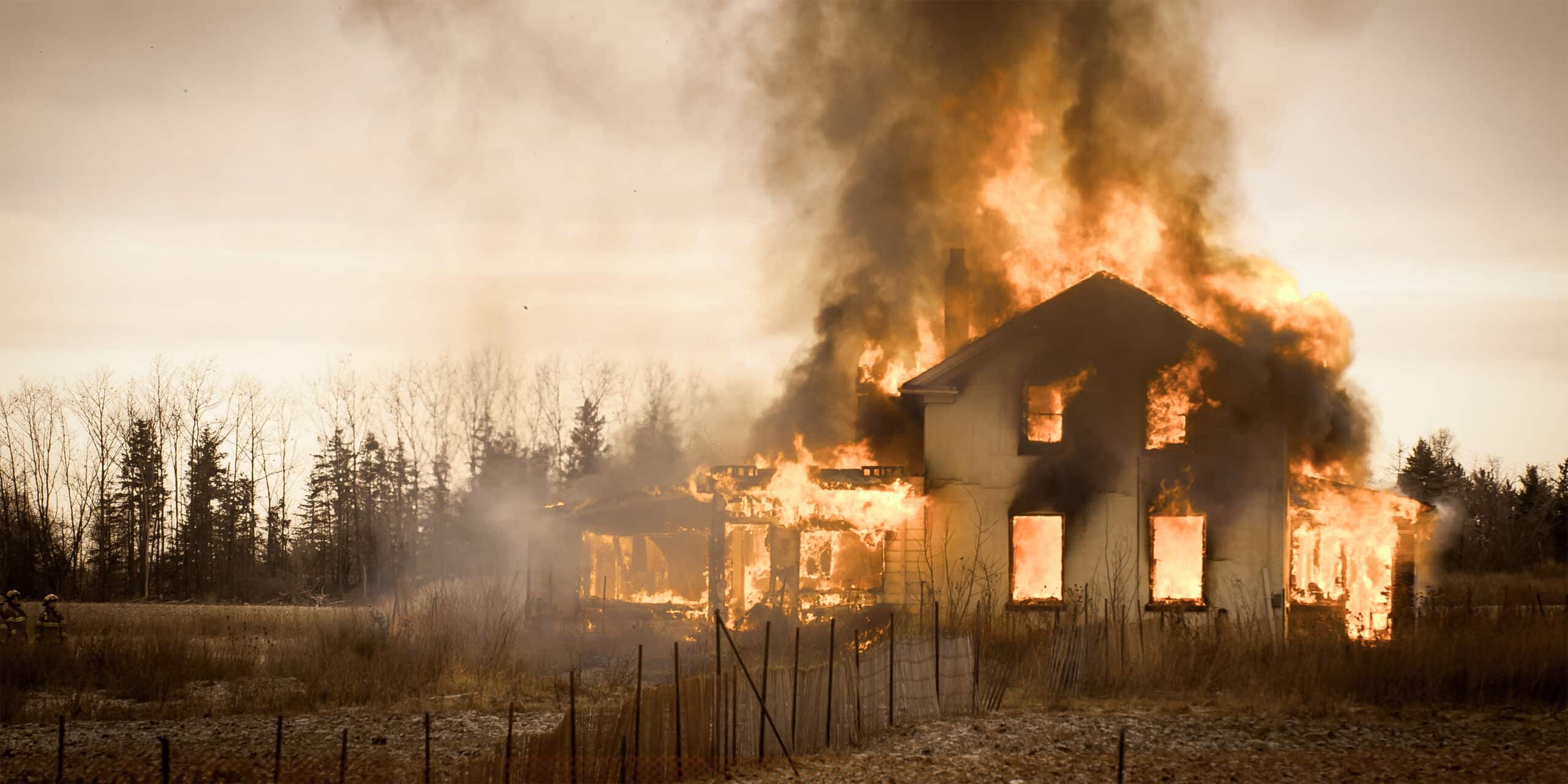Burning farm house in an empty field in Ontario Canada.