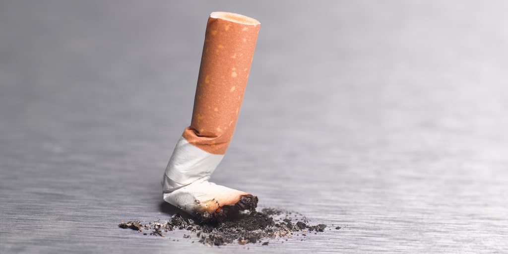 Close-up image of a cigarette butt stubbed out.