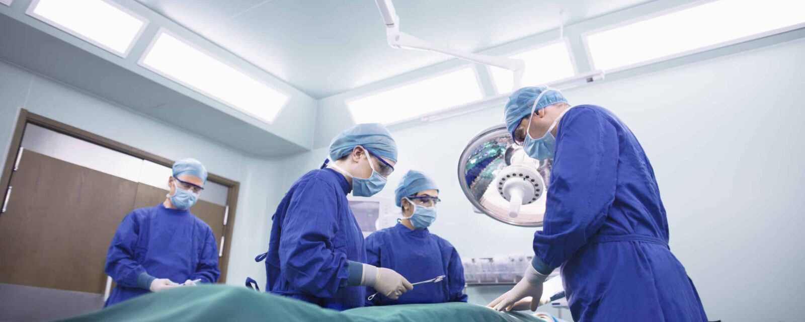 Operating room staff performing hospital surgery