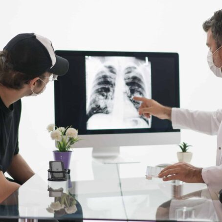 Doctor shows patient an x-ray and discusses the differences between mesothelioma and asbestosis.