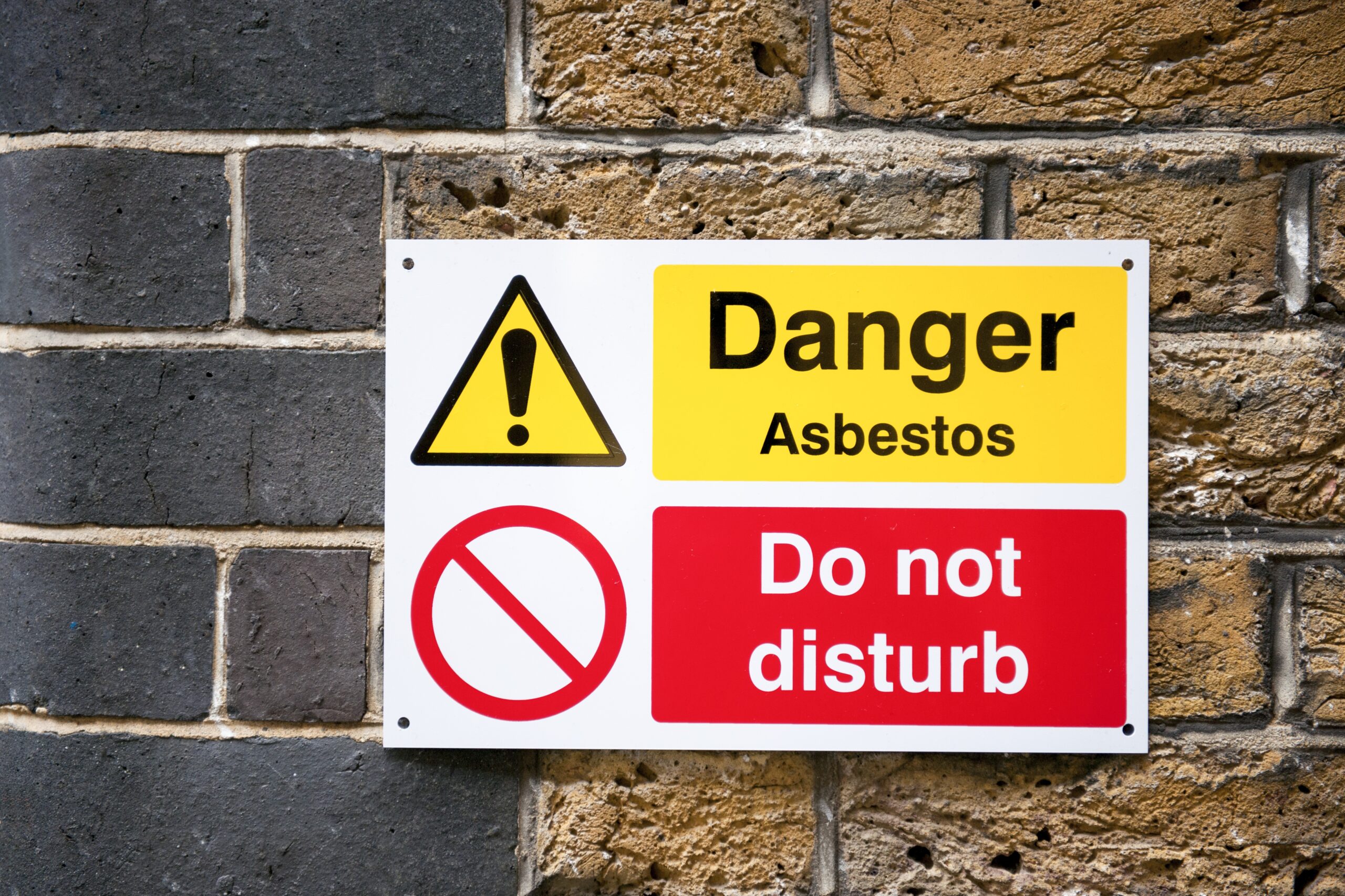 Sign stating: "Danger Asbestos" and "Do Not Disturb"