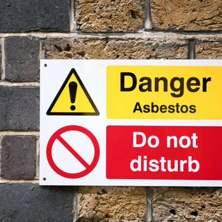 Sign stating: "Danger Asbestos" and "Do Not Disturb"