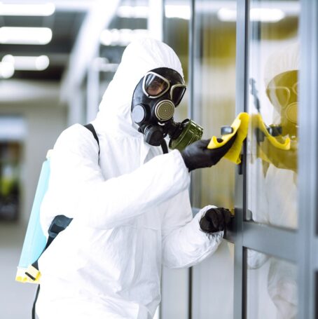 Image of asbestos removal technician in hazmat suit.