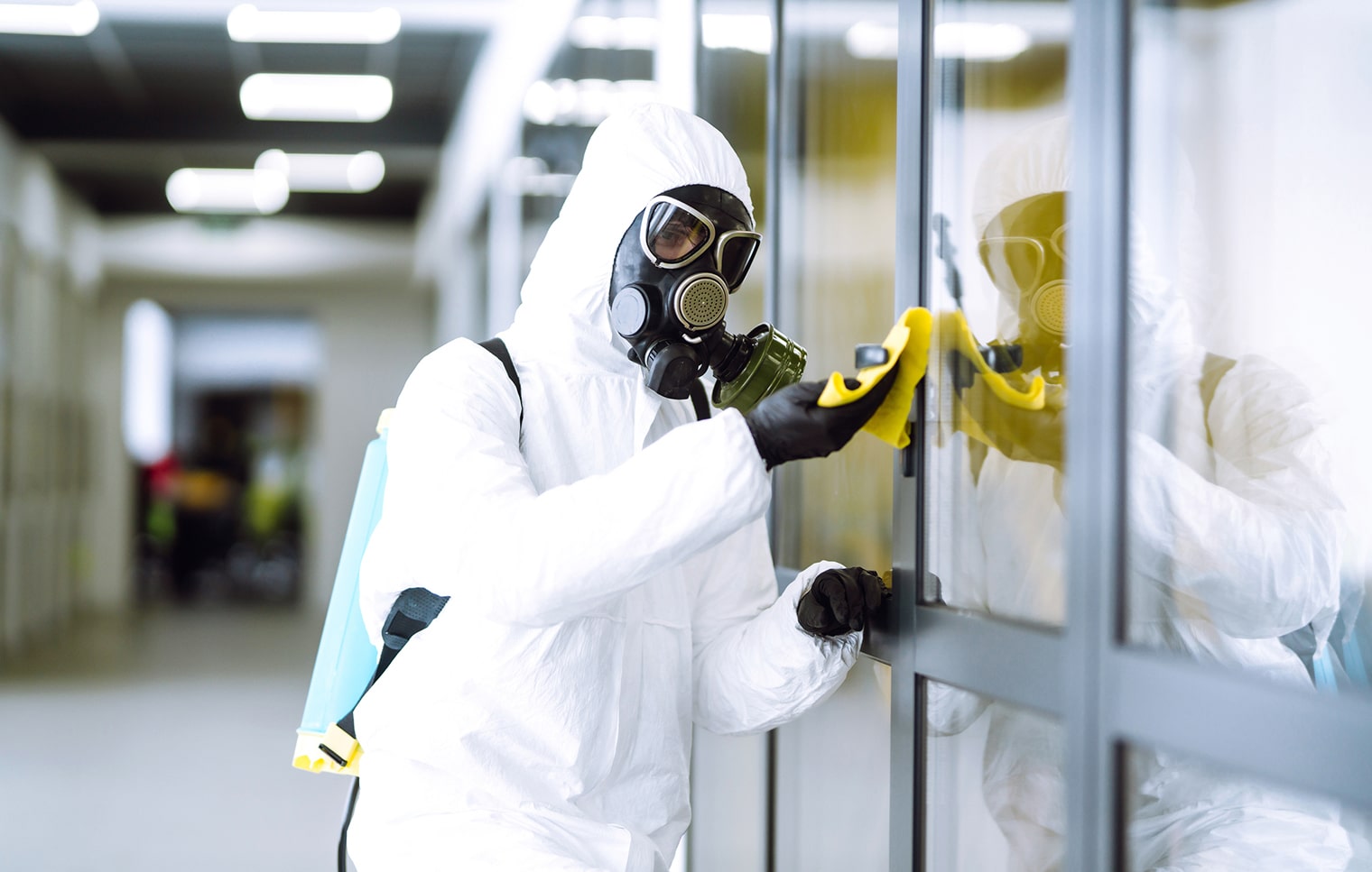 Image of asbestos removal technician in hazmat suit.