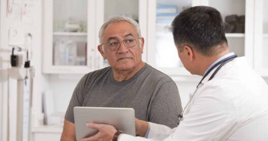 A doctor explaining a mesothelioma diagnosis, a fatal disease, to his patient.