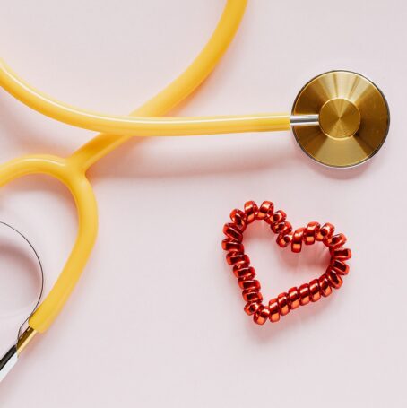Picture of a yellow stethoscope next to a red cord to celebrate National Doctors Day.