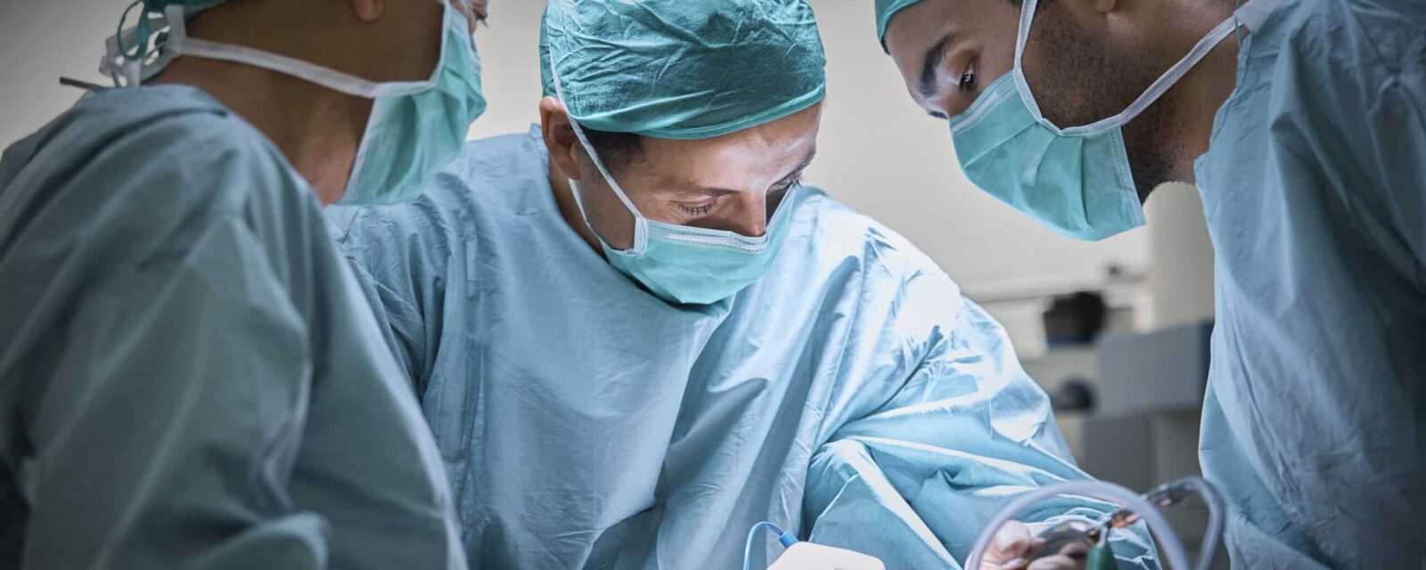 Thoracic surgeon performs chest cavity surgery on mesothelioma patient.