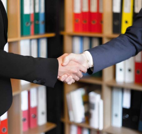 Community members of the ADAO meet and shake hands after discussing asbestos awareness and prevention of asbestos worldwide