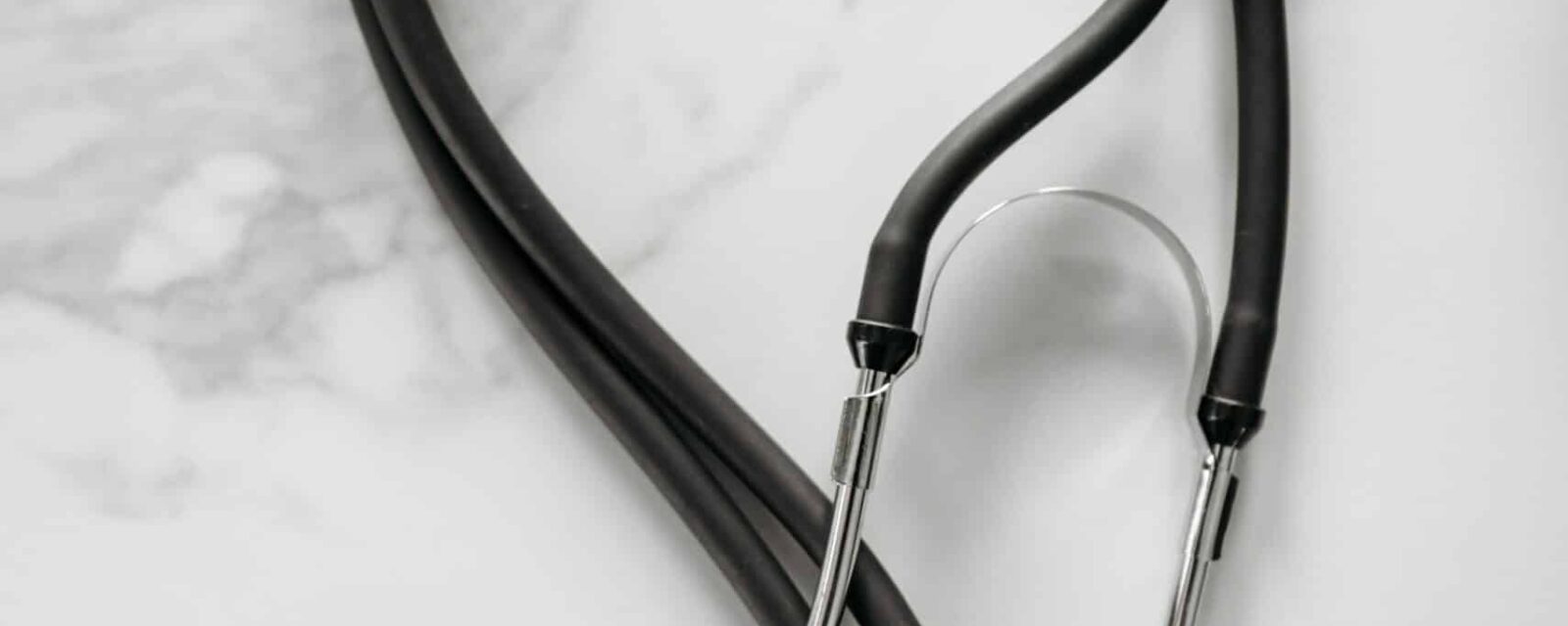 Image of stethoscope laying on marble counter.