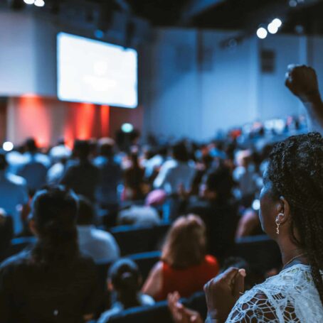 Woman raising hand at International Symposium on Malignant Mesothelioma.