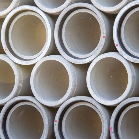 Cement pipes stacked on top of one another.