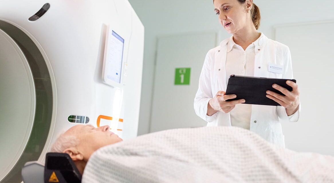 Radiation oncologists oversee radiation therapy on patient.