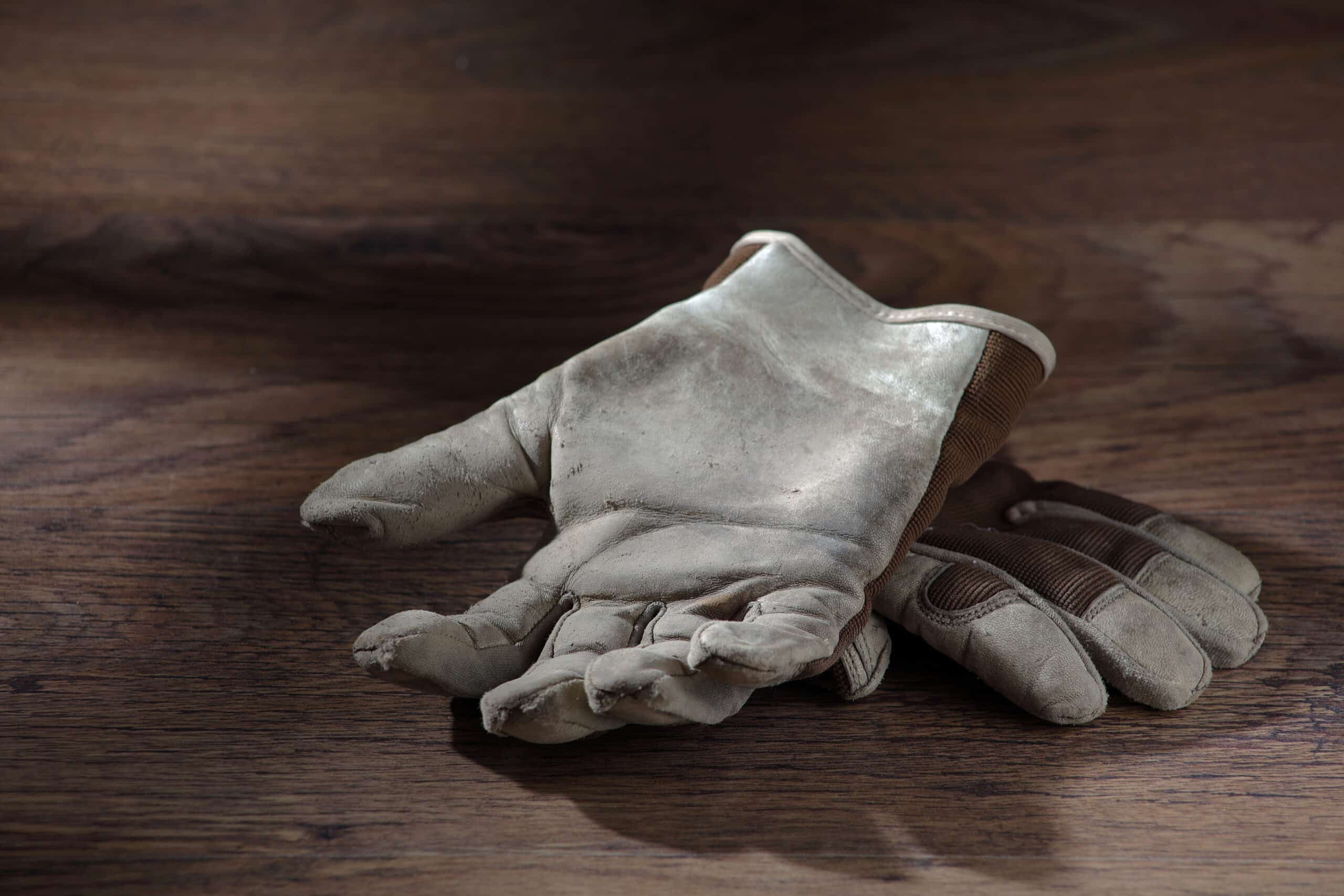 Pair of beige asbestos gloves laying on top of each other