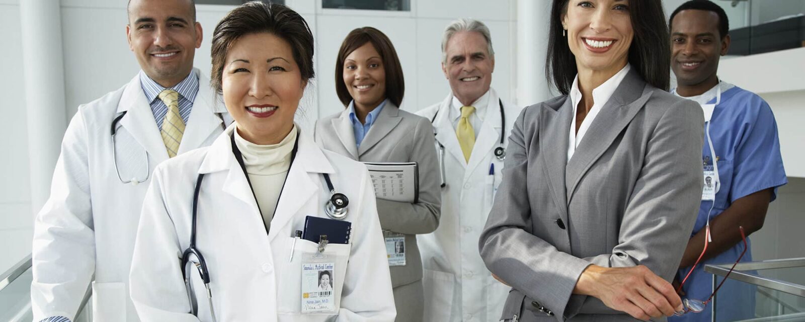 Group of doctors standing together and smiling at the camera.