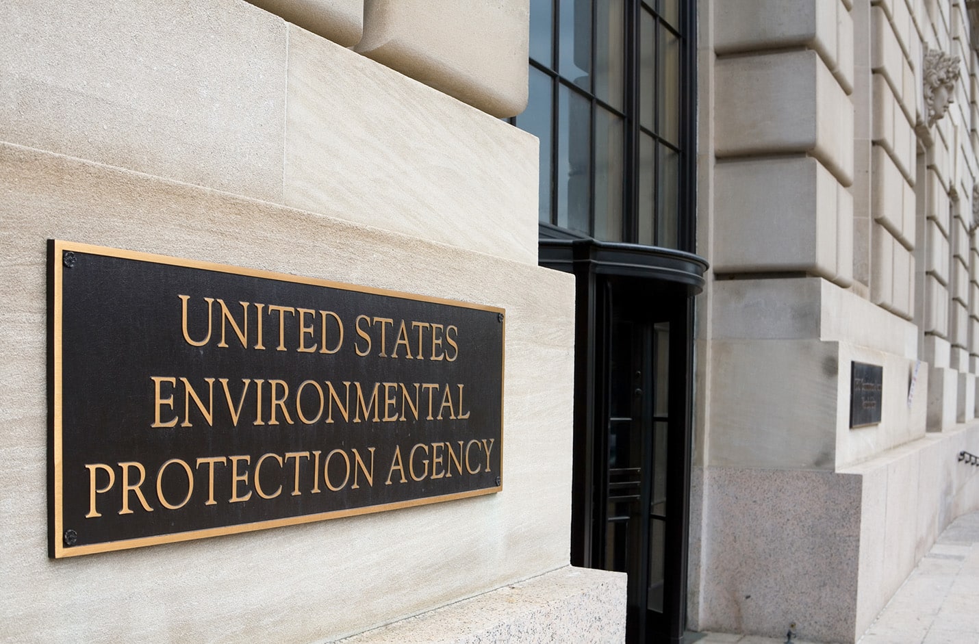Photograph of United States Environmental Protection Agency plaque on building where people can follow the new Asbestos Reporting Rule.