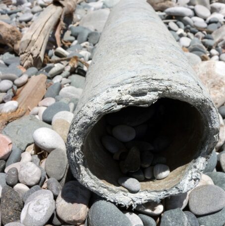 Asbestos pipe with a damaged asbestos gasket.