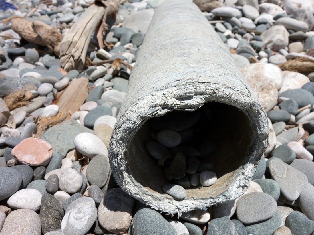 Asbestos pipe with a damaged asbestos gasket.