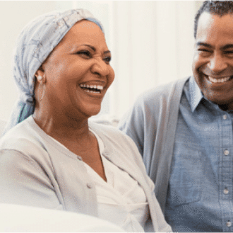 Woman in treatment and man smiling at each other.