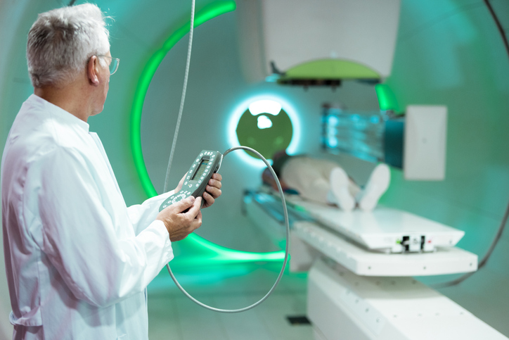 Doctor operating proton therapy equipment for cancer treatment in a hospital
