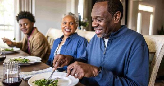 Senior man enjoying mesothelioma diet meal with family at dining table