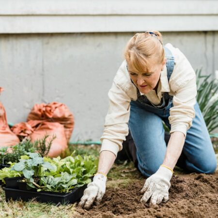Elderly woman with mesothelioma gardening to help manage cancer anxiety