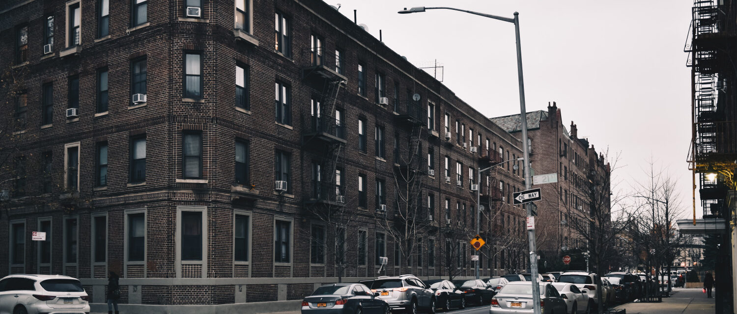 Historic apartment buildings and residential street in Brooklyn, New York, representing communities affected by asbestos exposure in older residential and commercial properties.
