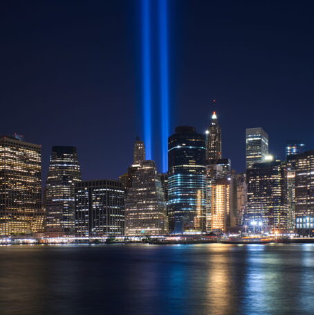 New York, skyline with Brooklyn Bridge at night. In the background is seen Manhattan skyline with the One World Trade Center - Freedom Tower and Beekman Tower on the right side, the tallest residential tower in the world, designed by Frank Gehry.