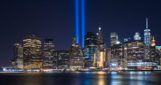 New York, skyline with Brooklyn Bridge at night. In the background is seen Manhattan skyline with the One World Trade Center - Freedom Tower and Beekman Tower on the right side, the tallest residential tower in the world, designed by Frank Gehry.