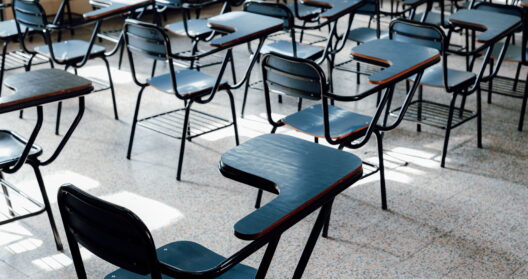 Rows of empty desks in classroom